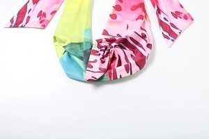 Detail of vibrant abstract print fabric with high-saturation pink, yellow, and blue ink tones