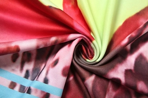 Macro detail of the abstract tie-dye printed fabric showing soft texture and vivid colors
