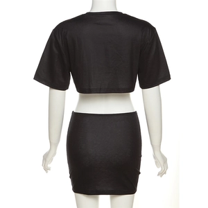 Back view of a black two-piece set featuring a short sleeve crop top and mini skirt on a mannequin