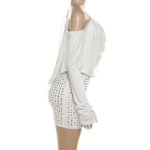 Detail of white two-piece set featuring silver square studs on a bodycon mini skirt