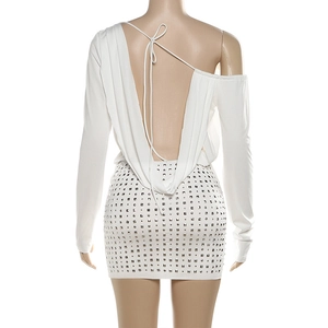 Detail of white backless dress with silver square studs and stylish lace-up back design