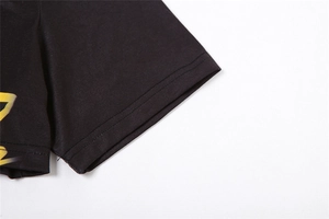 Detail of black knit sleeve with double-needle stitching and yellow graphic print