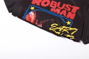 Detail of crop top hem featuring bold ROBUST MAN print and vintage graphic patterns
