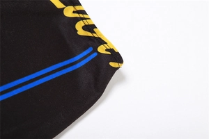 Close-up of printed lettering and blue stripes on black elastic polyester fabric