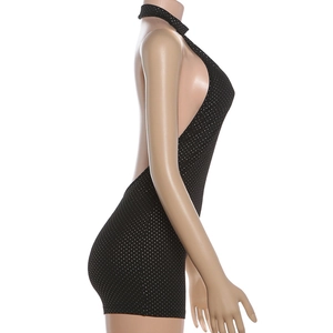 Macro detail of sexy backless halter neck romper in black with sparkly white polka dots