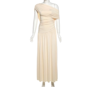 Detail of elegant apricot one-shoulder maxi dress with ruched fabric texture