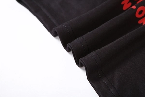 Detail of black cotton knit fabric with red MOR lettering and double needle stitching