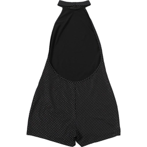 Detail of the backless halter jumpsuit with classic white polka dots on black fabric