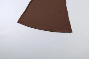 Detailed view of the double-stitched hem on the brown jersey slim fit maxi dress