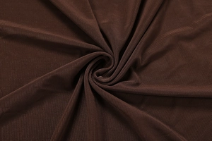 Close-up of dark brown fine mesh fabric texture with spiral layered pleats