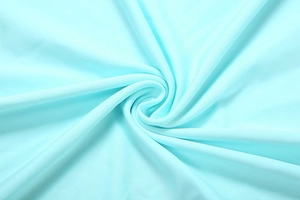 Detail of light blue high-density knit fabric with elegant spiral texture and soft drape
