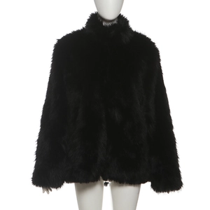 Close-up detail of high-density black faux fur texture on a stand collar jacket