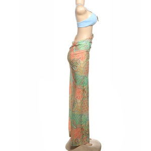 Detail of light blue halter bikini top and multi-color paisley print sarong beach skirt