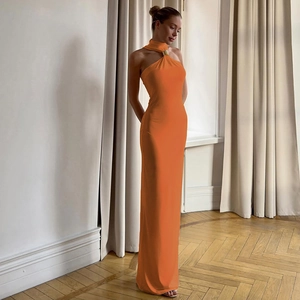 Detail of orange halter neck dress with premium gold metal ring accent at the neckline