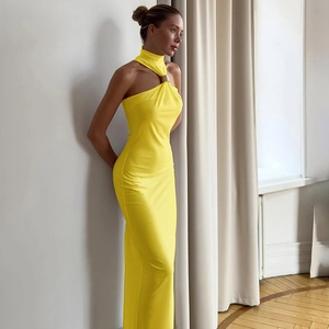 Close-up of the metal ring buckle detail on a yellow halter neck slimming maxi dress