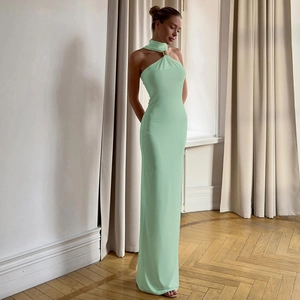 Detail of mint green halter neck dress with gold metal ring buckle and pleated fabric
