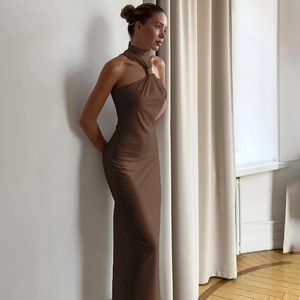 Detail of elegant gold metal ring fastener on a brown halter neck slim fit maxi dress