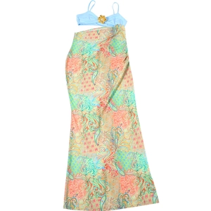 Detail of blue camisole top with 3D gold flower accent and colorful paisley print maxi skirt