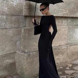 Detail of the elegant backless design and slim fit of the long black evening dress