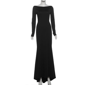 Detail of elegant black off-shoulder maxi dress with long sleeves and fisheye hemline