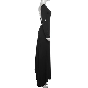 Detailed view of backless black maxi dress with gold chain straps and slim fit silhouette