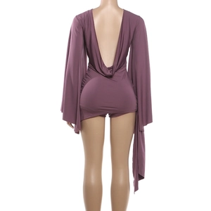 Detail of deep purple open-back romper featuring wide flared sleeves and draped back design