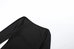 Close-up detail of boat neck collar and chain strap on black slim-fit jersey dress