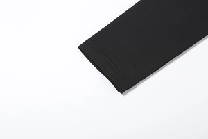 Detailed close-up of professional double-needle stitching on the black dress sleeve cuff