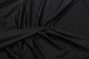 Macro shot of black twist-knot fabric detail with smooth texture and fine stitching