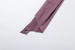 Detailed macro view of seamless cut edge and smooth purple fabric texture on bodysuit