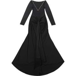 Detail of backless black dress featuring gold chain straps and pleated texture