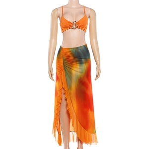 Detail of colorful tie-dye maxi skirt with high slit and ruffled edges in resort set
