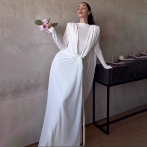 Detail of elegant white long sleeve maxi dress with waist pleats and padded shoulders