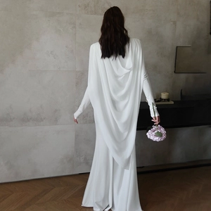 Elegant white maxi dress featuring a sophisticated draped back design and long sleeves