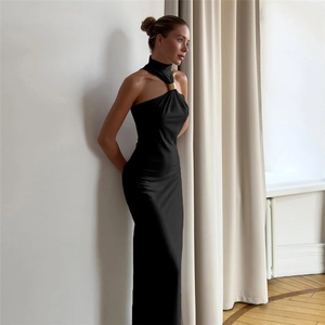 Detail of the golden metal collar buckle on the black halter neck bodycon maxi dress