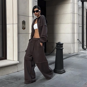 Detailansicht der Außennähte an dunkelbraunem Oversized-Hoodie und weiten Jogginghosen