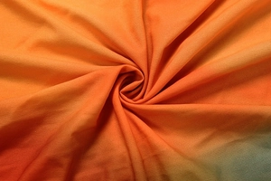 Detailed macro view of orange gradient ribbed knit fabric with fine vertical stripe texture