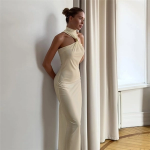 Detail view of cream-colored halter neck maxi dress with elegant gold metal ring buckle
