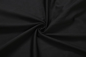 Close-up of black textured stretch fabric showing fine weave and soft matte finish