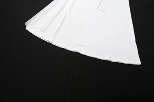 Detailed close-up of the smooth white mesh hemline with precise stitching on a dress