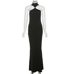Detailed view of elegant black halter neck dress featuring a metallic gold ring fastener