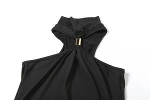 Detailed view of black halter neck dress featuring a golden metal cylinder buckle detail