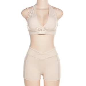 Détail du short de yoga taille haute avec poche latérale et taille croisée en beige