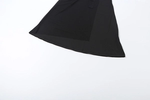 Detail view of the layered black mesh hemline on a slim-fit evening maxi dress