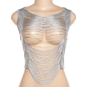 Macro shot of silver metallic fringe fabric with cutout details on a sleeveless top
