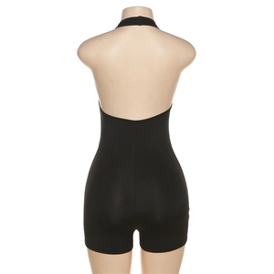 Detail of black halter backless romper featuring stretch fabric and slim fit on mannequin