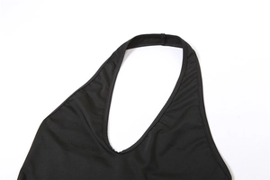 Close-up of the black halter neckline with neat stitching and smooth fabric texture
