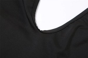 Macro shot of V-neckline stitching and knitted fabric texture on a black romper
