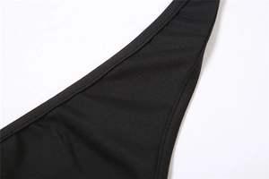 Close-up of black tight romper with detailed seam stitching and textured fabric finish