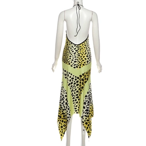 Detail view of the backless halter neck strap and bold leopard print on the maxi dress